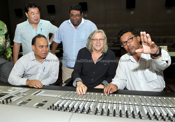MEET THE EXPERT: Christian (second right) tries the ‘Audio Console Euphonix’  during his visit to Finas. — Bernama photo