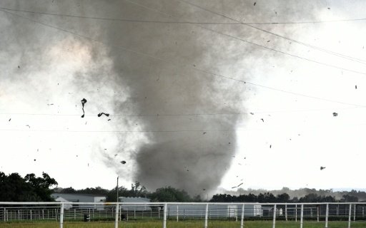 Debris flies through the air as a tornado rips through a residential area south of Wynnewood, Oklahoma on May 9, 2016 -AFP