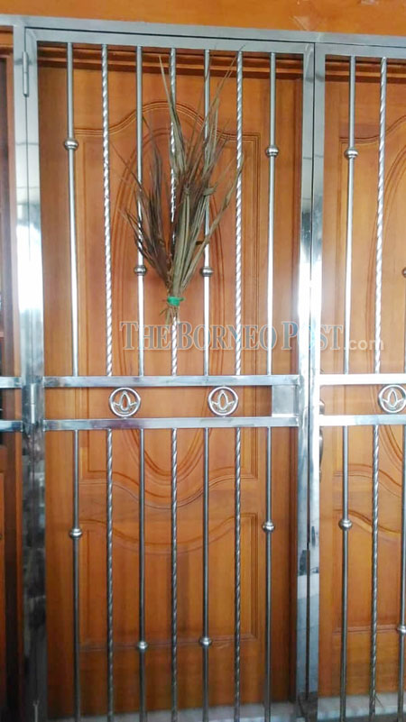 Catholics hang palm leaves on doors to mark Palm Sunday